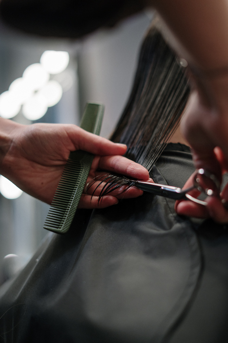 Person Holding Black Hair Comb